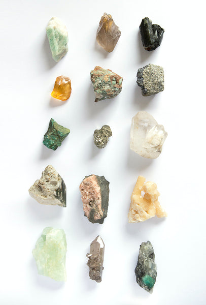 Photography credits: Franco Antonio Giovanella. Flat lay of earth stones and quartz on table.